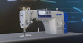 Juki industrial sewing machine with illuminated workspace.